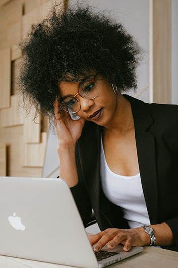 woman on laptop and phone woman on laptop and phone